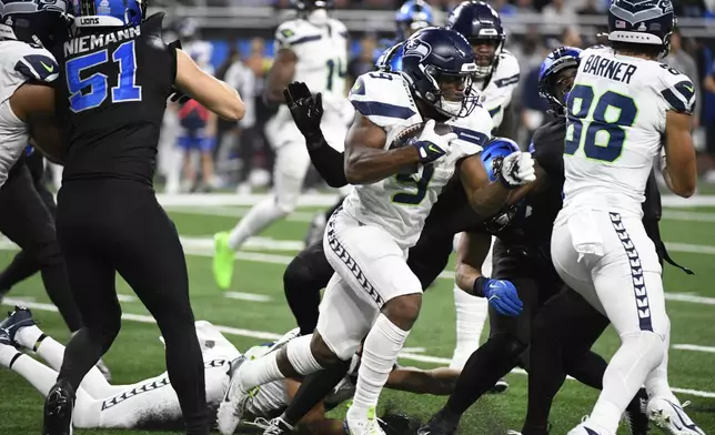 Seattle Seahawks running back Kenneth Walker III (9) rushes during the second half of an NFL football game against the Detroit Lions, Monday, Sept. 30, 2024, in Detroit. (AP Photo/Jose Juarez)