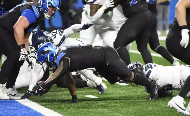 Detroit Lions running back David Montgomery falls into the endzone for a 1-yard rushing touchdown during the first half of an NFL football game against the Seattle Seahawks, Monday, Sept. 30, 2024, in Detroit. (AP Photo/Jose Juarez)