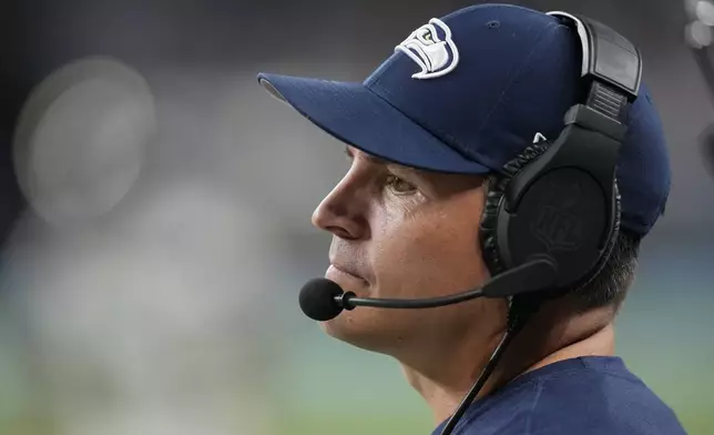 Seattle Seahawks head coach Mike MacDonald watches from the sideline during the second half of an NFL football game against the Detroit Lions, Monday, Sept. 30, 2024, in Detroit. (AP Photo/Paul Sancya)