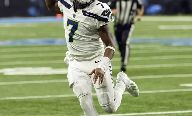 Seattle Seahawks quarterback Geno Smith rushes during the second half of an NFL football game against the Detroit Lions, Monday, Sept. 30, 2024, in Detroit. (AP Photo/Paul Sancya)