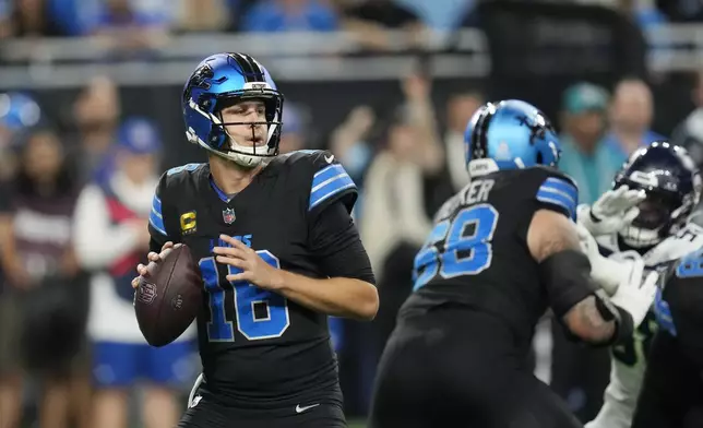 Detroit Lions quarterback Jared Goff looks to pass during the first half of an NFL football game against the Seattle Seahawks, Monday, Sept. 30, 2024, in Detroit. (AP Photo/Paul Sancya)