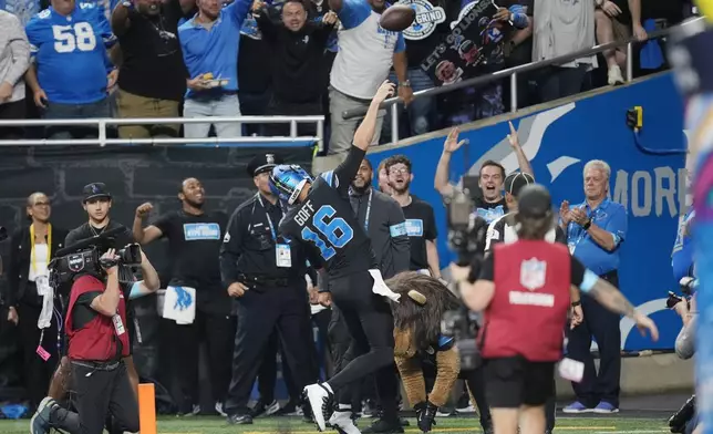 Detroit Lions quarterback Jared Goff tosses the football into the stands after his rushing touchdown during the second half of an NFL football game against the Seattle Seahawks, Monday, Sept. 30, 2024, in Detroit. (AP Photo/Paul Sancya)