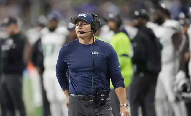 Seattle Seahawks head coach Mike MacDonald walks the sideline during the second half of an NFL football game against the Detroit Lions, Monday, Sept. 30, 2024, in Detroit. (AP Photo/Paul Sancya)