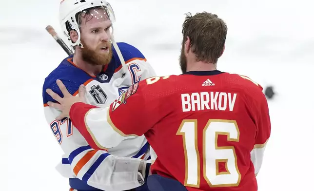 FILE - Edmonton Oilers forward Connor McDavid (97) congratulates Florida Panthers forward Aleksander Barkov (16) after Florida won Game 7 of the NHL hockey Stanley Cup Final in Sunrise, Fla., Monday, June 24, 2024. (Nathan Denette/The Canadian Press via AP, File)