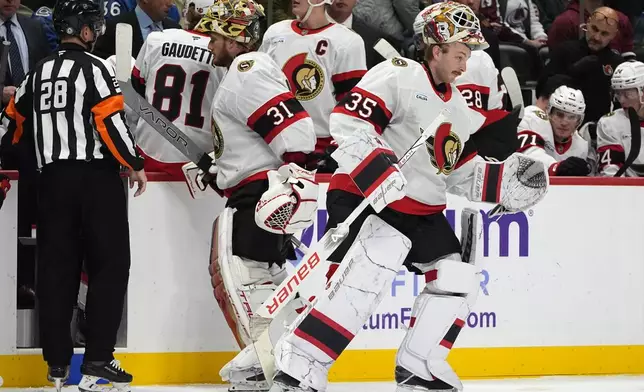 Ottawa Senators goaltender Linus Ullmark, right, skates out to the net to replace goaltender Anton Forsberg (31) who suffered an equipment failure in the second period of an NHL hockey game against the Colorado Avalanche, Sunday, Oct. 27, 2024, in Denver. (AP Photo/David Zalubowski)