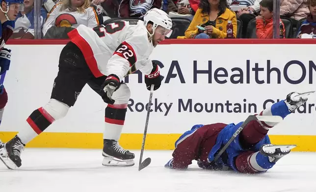 Colorado Avalanche right wing Nikolai Kovalenko, right, falls after he was tripped by Ottawa Senators right wing Michael Amadio (22) in the first period of an NHL hockey game Sunday, Oct. 27, 2024, in Denver. (AP Photo/David Zalubowski)