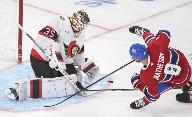 Montreal Canadiens' Mike Matheson (8) is tripped as he moves in on Ottawa Senators goaltender Linus Ullmark during the third period of an NHL hockey game, Saturday, Oct. 12, 2024 in Montreal. (Graham Hughes/Canadian Press via AP)