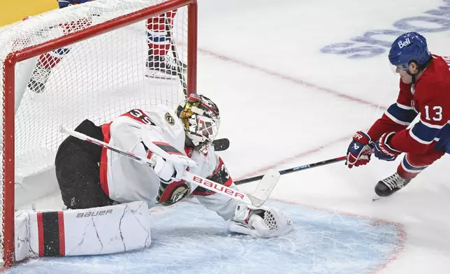 Montreal Canadiens' Cole Caufield (13) moves in to score on Ottawa Senators goaltender Linus Ullmarkduring the third period of an NHL hockey game, Saturday, Oct. 12, 2024 in Montreal. (Graham Hughes/Canadian Press via AP)