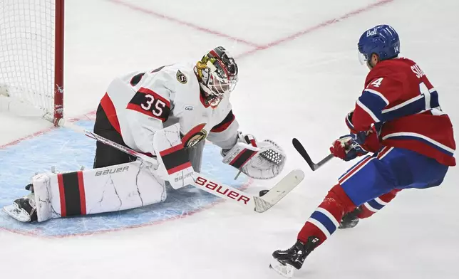 Montreal Canadiens' Nick Suzuki (14) is stopped by Ottawa Senators goaltender Linus Ullmark during the third period of an NHL hockey game, Saturday, Oct. 12, 2024 in Montreal. (Graham Hughes/Canadian Press via AP)