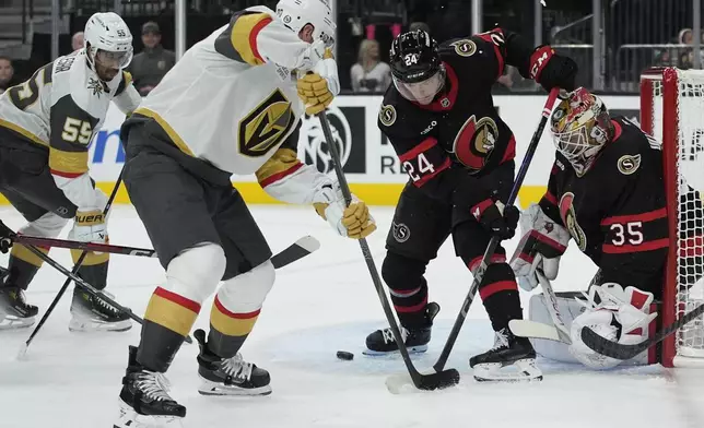 Ottawa Senators defenseman Jacob Bernard-Docker (24) attempts to knock the puck away from the net against the Vegas Golden Knights during the second period of an NHL hockey game Friday, Oct. 25, 2024, in Las Vegas. (AP Photo/John Locher)