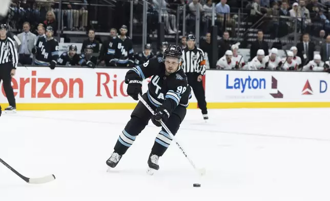 Utah Hockey Club defensemen Mikhail Sergachev (98) moves the puck during the second period against the Ottawa Senators at an NHL hockey game, Tuesday Oct 22, 2024, in Salt Lake City. (AP Photo/Melissa Majchrzak)