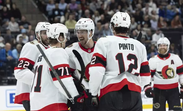 Ottawa Senators celebrate after forward Ridly Greig (71) scores against the Utah Hockey Club in the first period of an NHL hockey game, Tuesday Oct 22, 2024, in Salt Lake City. (AP Photo/Melissa Majchrzak)