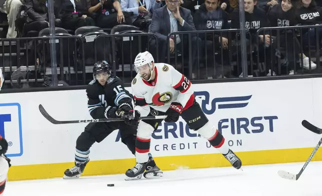 Utah Hockey Club Ottawa Senators forward Michael Amadio (22) fights for the puck against Utah Hockey Club Alexander Kerfoot (15) in the first period of an NHL hockey game, Tuesday Oct 22, 2024, in Salt Lake City. (AP Photo/Melissa Majchrzak)