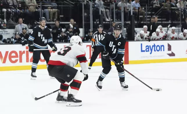 Utah Hockey Club forward Clayton Keller (9) moves the puck against Ottawa Senators forward Noah Gregor (73) during the second period of an NHL hockey game, Tuesday Oct 22, 2024, in Salt Lake City. (AP Photo/Melissa Majchrzak)