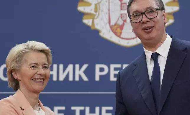 European Commission President Ursula von der Leyen, left, shakes hands with Serbian President Aleksandar Vucic after a news conference at the Serbia Palace in Belgrade, Serbia, Friday, Oct. 25, 2024. (AP Photo/Darko Vojinovic)