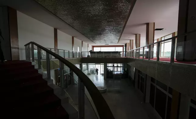 A security worker walks through Hotel Yugoslavia, once a symbol of progress in the former socialist state of Yugoslavia that broke apart in the 1990s and a favorite gathering place for local residents as well as world leaders, in Belgrade, Serbia, Thursday, Oct. 3, 2024. (AP Photo/Darko Vojinovic)