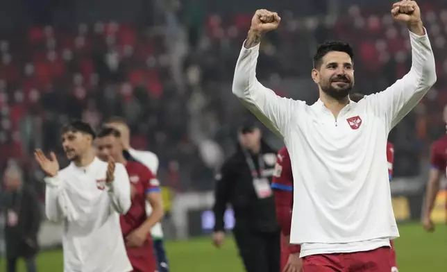 Serbia's Aleksandar Mitrovic celebrates after the UEFA Nations League soccer match between Serbia and Switzerland at the Dubocica Stadium in Leskovac, Serbia, Saturday, Oct. 12, 2024. (AP Photo/Darko Vojinovic)