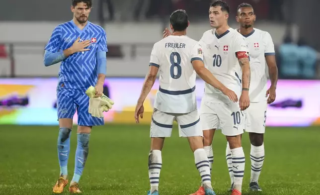 Switzerland's players leave the pitch after the UEFA Nations League soccer match between Serbia and Switzerland at the Dubocica Stadium in Leskovac, Serbia, Saturday, Oct. 12, 2024. (AP Photo/Darko Vojinovic)