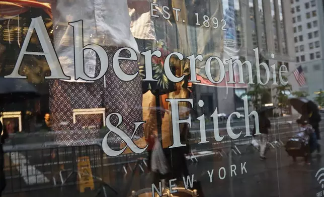 FILE - In this May 22, 2017, file photo, a store window reflects a street scene at an Abercrombie &amp; Fitch store on New York's Fifth Avenue. (AP Photo/Bebeto Matthews, File)