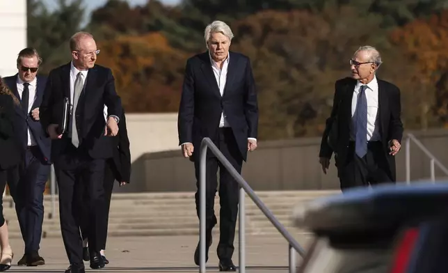 Michael Jeffries, center, former CEO of Abercrombie &amp; Fitch, exits the federal courthouse after his arraignment on sex trafficking and interstate prostitution charges, Friday, Oct. 25, 2024, in Central Islip, N.Y. (AP Photo/Heather Khalifa)