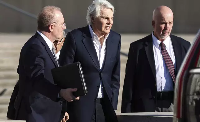 Michael Jeffries, former CEO of Abercrombie &amp; Fitch, center, exits the federal courthouse after his arraignment on sex trafficking and interstate prostitution charges, Friday, Oct. 25, 2024, in Central Islip, N.Y. (AP Photo/Heather Khalifa)