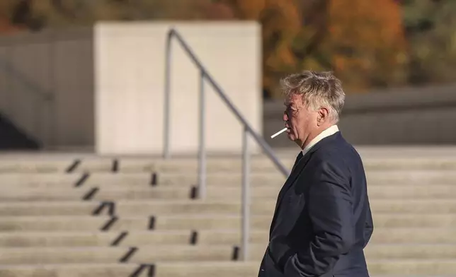 James Jacobson smokes outside of the federal courthouse after his arraignment on sex trafficking and interstate prostitution charges connected to the former CEO of Abercrombie &amp; Fitch, Friday, Oct. 25, 2024, in Central Islip, N.Y. (AP Photo/Heather Khalifa)