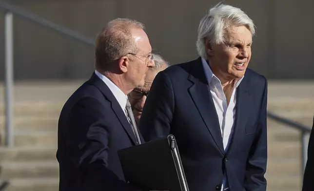 Michael Jeffries, former CEO of Abercrombie &amp; Fitch, right, exits the federal courthouse after his arraignment on sex trafficking and interstate prostitution charges, Friday, Oct. 25, 2024, in Central Islip, N.Y. (AP Photo/Heather Khalifa)