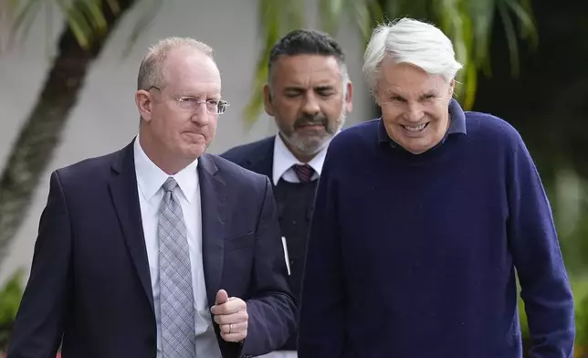 Michael Jeffries, right, former CEO of Abercrombie &amp; Fitch, leaves with his attorney Brian Bieber, left, following a hearing at the Paul G. Rogers Federal Building and U.S. Courthouse, in West Palm Beach, Fla., Tuesday, Oct. 22, 2024. (AP Photo/Rebecca Blackwell)