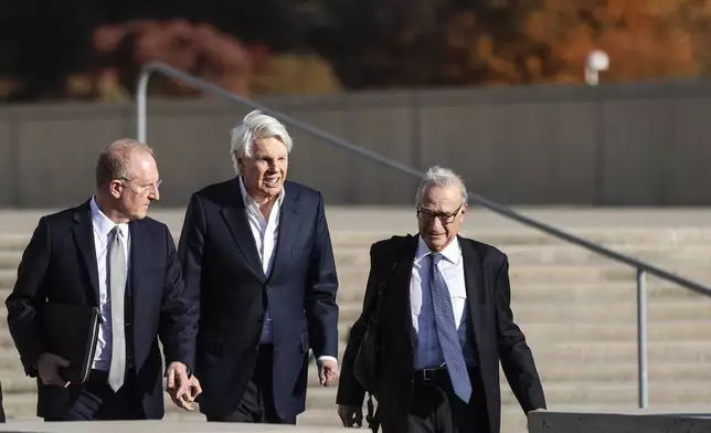 Michael Jeffries, former CEO of Abercrombie &amp; Fitch, center, exits the federal courthouse after his arraignment on sex trafficking and interstate prostitution charges, Friday, Oct. 25, 2024, in Central Islip, N.Y. (AP Photo/Heather Khalifa)