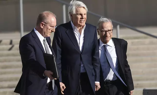 Michael Jeffries, center, former CEO of Abercrombie &amp; Fitch, exits the federal courthouse after his arraignment on sex trafficking and interstate prostitution charges, Friday, Oct. 25, 2024, in Central Islip, N.Y. (AP Photo/Heather Khalifa)