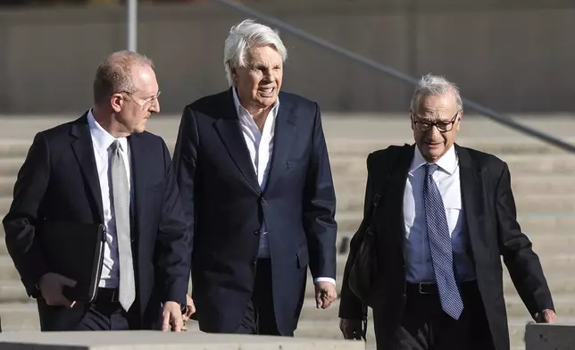 Michael Jeffries, former CEO of Abercrombie &amp; Fitch, center, exits the federal courthouse after his arraignment on sex trafficking and interstate prostitution charges, Friday, Oct. 25, 2024, in Central Islip, N.Y. (AP Photo/Heather Khalifa)