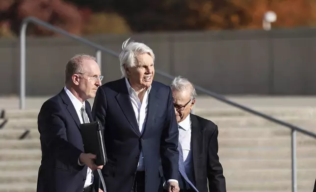 Michael Jeffries, former CEO of Abercrombie &amp; Fitch, center, exits the federal courthouse after his arraignment on sex trafficking and interstate prostitution charges, Friday, Oct. 25, 2024, in Central Islip, N.Y. (AP Photo/Heather Khalifa)