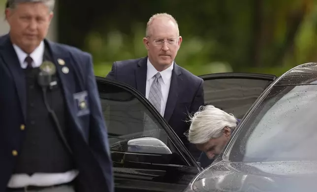 Michael Jeffries, right, former CEO of Abercrombie &amp; Fitch, gets into the car of his attorney, Brian Bieber, center, as they leave following a hearing at the Paul G. Rogers Federal Building and U.S. Courthouse, in West Palm Beach, Fla., Tuesday, Oct. 22, 2024. (AP Photo/Rebecca Blackwell)