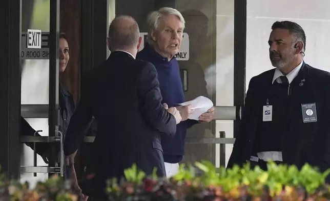 Michael Jeffries, center, former CEO of Abercrombie &amp; Fitch, leaves the Paul G. Rogers Federal Building and U.S. Courthouse following a hearing, in West Palm Beach, Fla., Tuesday, Oct. 22, 2024. (AP Photo/Rebecca Blackwell)