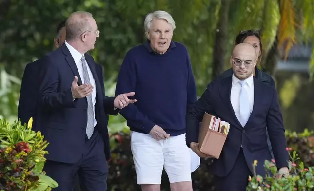 Michael Jeffries, center, former CEO of Abercrombie &amp; Fitch, leaves with his attorney Brian Bieber, left, following a hearing at the Paul G. Rogers Federal Building and U.S. Courthouse, in West Palm Beach, Fla., Tuesday, Oct. 22, 2024. (AP Photo/Rebecca Blackwell)