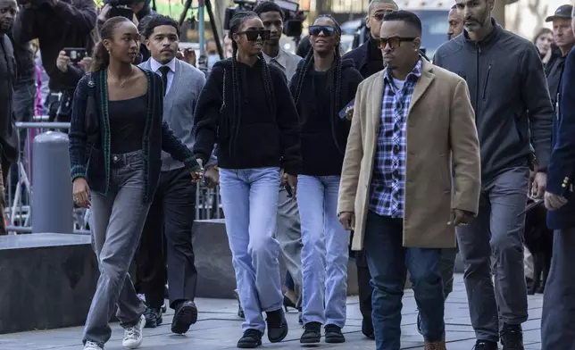 D'Lila Combs and Jessie Combs, center, twin daughters of Sean "Diddy Combs, arrive at Manhattan federal court, Thursday, Oct. 10 2024, in New York. (AP Photo/Yuki Iwamura)