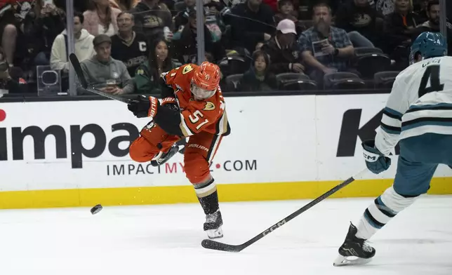 Anaheim Ducks defenseman Olen Zellweger (51) shoots past San Jose Sharks defenseman Cody Ceci (4) during the first period of an NHL hockey game, Tuesday, Oct. 22, 2024, in Anaheim, Calif. (AP Photo/Kyusung Gong)