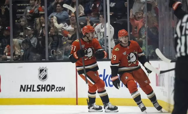 Anaheim Ducks left wing Cutter Gauthier (61) reacts on a goal by right wing Troy Terry (19) during the second period of an NHL hockey game against the San Jose Sharks, Tuesday, Oct. 22, 2024, in Anaheim, Calif. (AP Photo/Kyusung Gong)