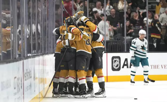 Vegas Golden Knights celebrate after scoring against the San Jose Sharks during the first period of an NHL hockey game Saturday, Oct. 26, 2024, in Las Vegas. (AP Photo/Lucas Peltier)