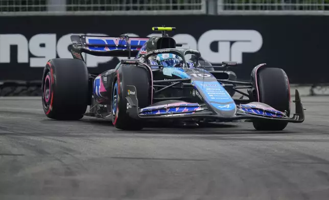 Alpine driver Pierre Gasly of France steers his car during the third practice session of the Singapore Formula One Grand Prix at the Marina Bay Street Circuit, in Singapore, Saturday, Sept. 21, 2024. (AP Photo/Vincent Thian)