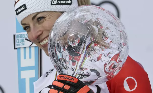FILE - Switzerland's Lara Gut Behrami poses with the alpine ski, women's World Cup overall trophy, in Saalbach, Austria, on March 23, 2024. (AP Photo/Marco Trovati)
