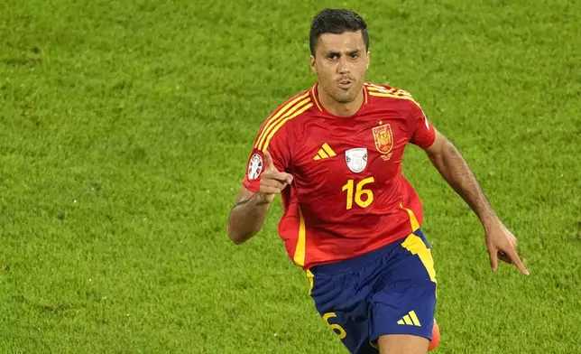 FILE - Spain's Rodri celebrates after scoring his side's opening goal during a round of sixteen match against Georgia at the Euro 2024 soccer tournament in Cologne, Germany, Sunday, June 30, 2024. (AP Photo/Andreea Alexandru, File)