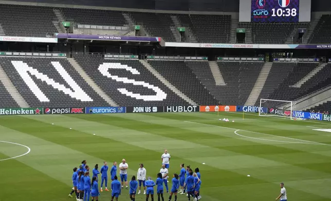 FILE _ France's manager Corinne Diacre talks to players during a training session ahead of the Women Euro 2022 semi final soccer match between Germany and France, at MK stadium in Milton Keynes, England, Tuesday, July 26, 2022. (AP Photo/Alessandra Tarantino, FIle)