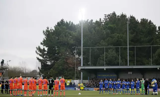 FILE - Millwall, left, and Wimbledon players observe a minute of silence in memory of late England's goalkeeper Gordon Banks prior to the start of the English FA Cup 5th round soccer match between Wimbledon and Millwall at Kingsmeadow ground stadium in London, Saturday, Feb. 16, 2019. (AP Photo/Tim Ireland, File)