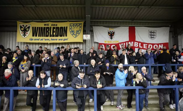 FILE - Wimbledon's fans wait for the start of the English FA Cup 5th round soccer match between Wimbledon and Millwall at Kingsmeadow ground stadium in London, Saturday, Feb. 16, 2019. (AP Photo/Tim Ireland, File)