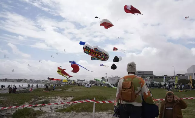 People fly kites at the Cape Town International Kite Festival in Cape Town, South Africa, Sunday, Oct. 27, 2024. (AP Photo/Nardus Engelbrecht)