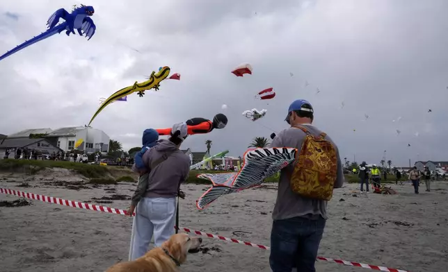 People fly kites at the Cape Town International Kite Festival in Cape Town, South Africa, Sunday, Oct. 27, 2024. (AP Photo/Nardus Engelbrecht)