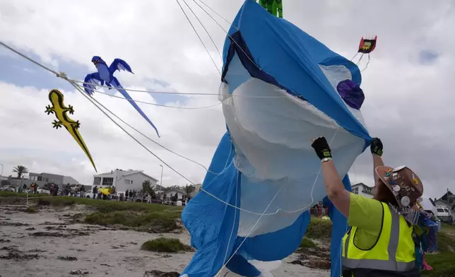 South African kite maker Mari Ware-Lane flies kites at the Cape Town International Kite Festival in Cape Town, South Africa, Sunday, Oct. 27, 2024. (AP Photo/Nardus Engelbrecht)