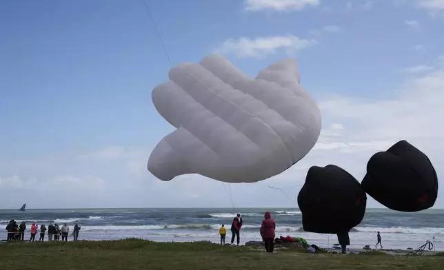 People fly kites at the Cape Town International Kite Festival in Cape Town, South Africa, Sunday, Oct. 27, 2024. (AP Photo/Nardus Engelbrecht)