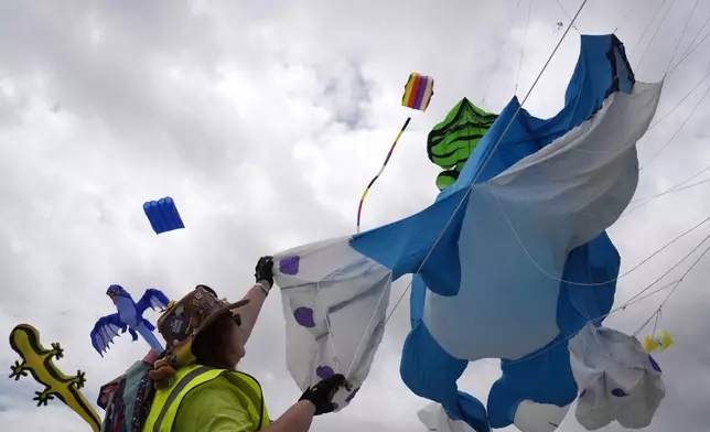 South African kite maker Mari Ware-Lane flies kites at the Cape Town International Kite Festival in Cape Town, South Africa, Sunday, Oct. 27, 2024. (AP Photo/Nardus Engelbrecht)